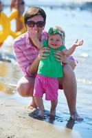 mom and baby on beach  have fun photo