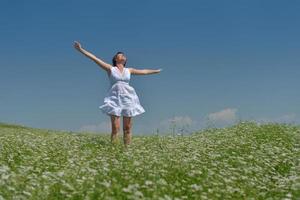 Young happy woman in green field photo