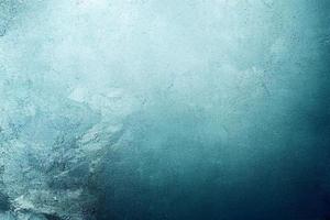 A computer generated illustration of a grunge wall surface texture background in blue, teal, turquoise colour. A.I. generated art. photo