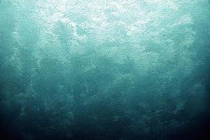 A computer generated illustration of a grunge wall surface texture background in blue, teal, turquoise colour. A.I. generated art. photo
