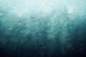 A computer generated illustration of a grunge wall surface texture background in blue, teal, turquoise colour. A.I. generated art. photo