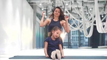 Instructor and student practice in gymnastics studio video