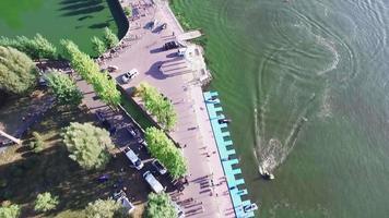 Aerial view of the shore, boardwalk, sailing boats, jet ski video