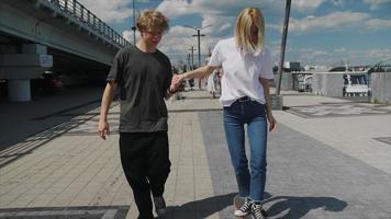 Two young people practice skateboarding video