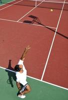 young man play tennis outdoor photo