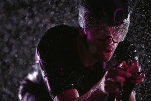 triathlon athlete riding bike  fast on rainy night photo