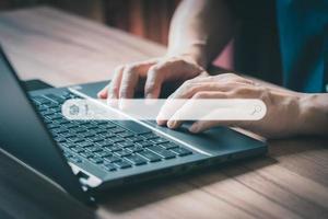 Man using laptop in the room for searching browsing internet data information. Business concept for Using search with your website. photo