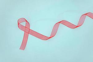 Closeup red ribbon awareness on White background for World Aids day campaign. Healthcare and medicine concept. photo