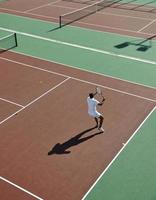 young man play tennis photo