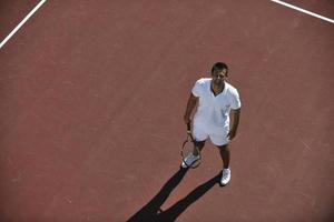 young man play tennis photo