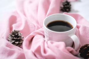 Christmas composition. Cup of coffee, scarf on pink background. Christmas, winter concept. Flat lay, top view, copy space photo