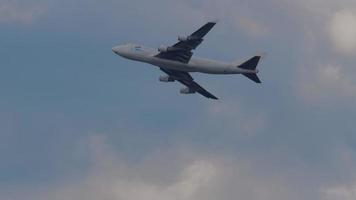 NOVOSIBIRSK, RUSSIAN FEDERATION JUNE 27, 2021 - Huge airplane jumbojet boeing 747 in flight passing overhead slow motion, cargo airlines. ASL Boeing cargo carrier flies in the sky video