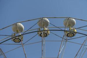 Ferris wheel on the background of blue sky photo