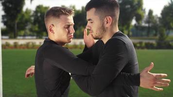 Two young men training at grass field video