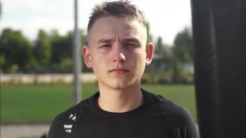 Close up Young man looking at camera at sport practice video