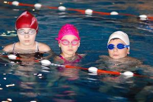 .childrens having fun in a swimming pool photo