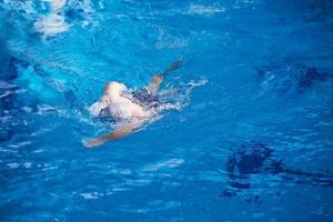 swimmer excercise on indoor swimming poo photo