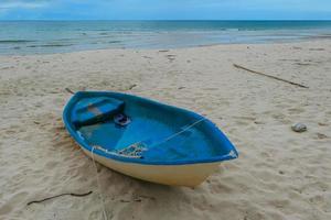 fisherman boat on the Beautiful beach in the morning with rain cloud. photo