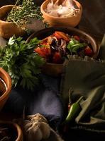 A vertical shot of a chef serving a gourmet salad dish photo