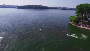 Aerial view of the shore, boardwalk, sailing boats, jet ski video