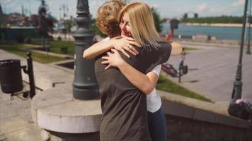 giovane ragazza e ragazzo avere un' abbraccio su un' soleggiato pomeriggio nel un' città parco