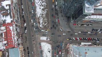 Aerial view of snowy Kyiv or Kiev city, top view of streets and cars video