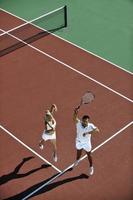 happy young couple play tennis game outdoor photo