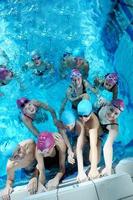 happy children group  at swimming pool photo