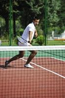 young man play tennis outdoor photo