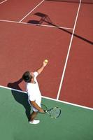 young man play tennis outdoor photo