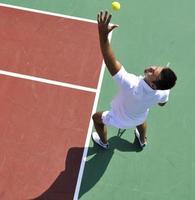 joven jugar al tenis al aire libre foto