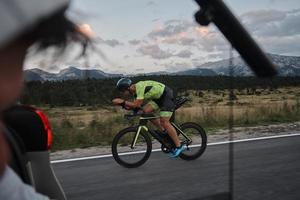 cinematographer taking action shot of triathlon bike athlete photo