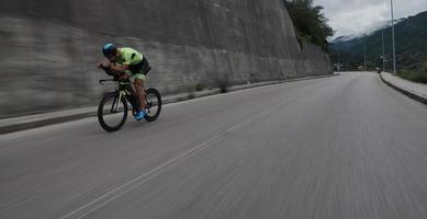 triathlon athlete riding a bike on morning training photo