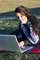 young teen girl work on laptop outdoor photo