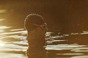 triathlete swimmer having a break during hard training photo