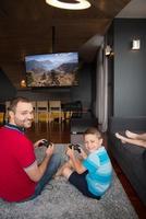 Happy family playing a motocross video game photo