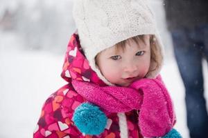 little girl have fun at snowy winter day photo