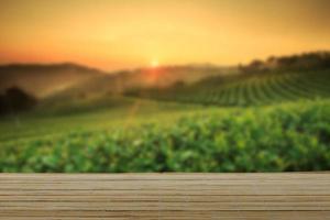 Empty wooden table with view of mountain or wooden desk with plantation nature with bokeh background, copy space for your text photo