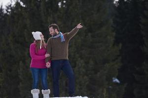 couple having fun and walking in snow shoes photo