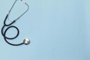 Creative flatlay of doctor medical equipment blue table with stethoscope, Health care concept, Top view with copy space, Isolated on blue photo