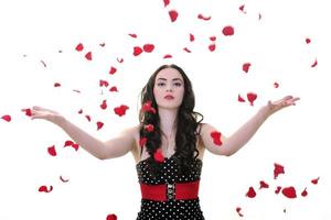 woman with falling rose petals photo