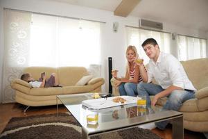 couple at home eating  pizza photo