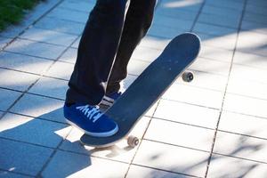 Skateboard jumping on sidewalk photo