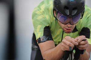 closeup of triathlon athlete riding bike photo