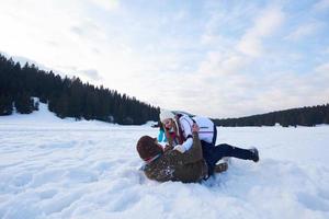 happy family playing together in snow at winter photo