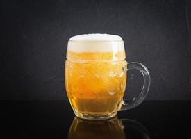 Mug of light beer on dark background. Craft unfiltered beer photo