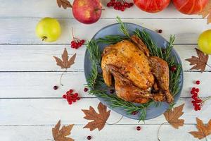 Baked whole chicken or turkey. Roasted homemade chicken with herbs. Thanksgiving day decoration. Top view photo