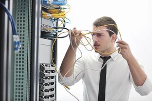 young engeneer in datacenter server room photo