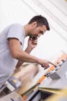 engineer in front of wood cutting machine photo