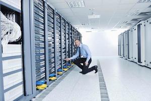 young it engineer in datacenter server room photo